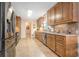 Galley kitchen with stainless steel appliances, wooden cabinets, and a neutral backsplash at 1310 Chilton Woods Rd, Rutledge, GA 30663