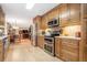 Spacious kitchen with stainless steel appliances, wooden cabinets, and an eat-in area at 1310 Chilton Woods Rd, Rutledge, GA 30663