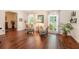 Bright living room featuring polished hardwood floors, floral chairs, and natural light through windows at 1310 Chilton Woods Rd, Rutledge, GA 30663