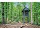 Charming wooded property featuring a custom-built treehouse and swing set for outdoor enjoyment at 1310 Chilton Woods Rd, Rutledge, GA 30663