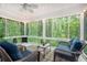 Sunroom filled with light and views of the trees in the backyard at 1310 Chilton Woods Rd, Rutledge, GA 30663