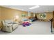 Finished basement featuring carpet, sofas, a decorated table, and recreational items at 2722 Brookhaven Ln, Buford, GA 30518