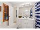 Bright bathroom featuring tile floors, vanity with sink, and window with shutter at 2722 Brookhaven Ln, Buford, GA 30518