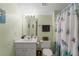 Bathroom with light green walls, updated vanity, and shower with a marine-themed curtain at 2722 Brookhaven Ln, Buford, GA 30518