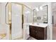 Bathroom featuring a gold-framed shower and a dark vanity at 2722 Brookhaven Ln, Buford, GA 30518