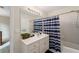 Bright bathroom with blue and white striped shower curtain and white vanity at 2722 Brookhaven Ln, Buford, GA 30518