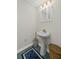 Charming powder room with pedestal sink and decorative mirror at 2722 Brookhaven Ln, Buford, GA 30518