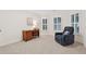 Spare bedroom with neutral carpet, blue recliner, and natural light at 2722 Brookhaven Ln, Buford, GA 30518