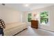 Cozy bedroom with a twin bed, carpet and two windows overlooking trees at 2722 Brookhaven Ln, Buford, GA 30518