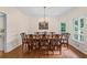 Formal dining room with a large table, chandelier, and natural light from surrounding windows at 2722 Brookhaven Ln, Buford, GA 30518