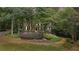 Charming two-story home with a welcoming front porch and beautifully landscaped front yard, surrounded by mature trees at 2722 Brookhaven Ln, Buford, GA 30518