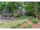 Charming two-story home with a welcoming front porch and beautifully landscaped front yard, surrounded by mature trees at 2722 Brookhaven Ln, Buford, GA 30518