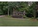 Charming two-story home with a welcoming front porch and beautifully landscaped front yard, surrounded by mature trees at 2722 Brookhaven Ln, Buford, GA 30518