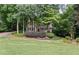 Charming two-story home with a welcoming front porch and beautifully landscaped front yard, surrounded by mature trees at 2722 Brookhaven Ln, Buford, GA 30518