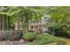 Charming two-story home with a welcoming front porch and beautifully landscaped front yard, surrounded by mature trees at 2722 Brookhaven Ln, Buford, GA 30518