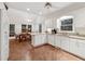 Bright kitchen featuring white cabinets, granite countertops, and a breakfast area at 2722 Brookhaven Ln, Buford, GA 30518