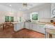 Open kitchen with white cabinets, granite countertops, and adjacent breakfast nook at 2722 Brookhaven Ln, Buford, GA 30518