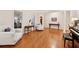 Bright living room with hardwood floors, piano, white armchairs, and detailed trim, inviting and elegant at 2722 Brookhaven Ln, Buford, GA 30518