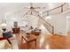 Open-concept living area with vaulted ceilings, hardwood floors, staircase, and combined dining area at 2722 Brookhaven Ln, Buford, GA 30518