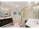A luxurious main bathroom features a soaking tub and a separate glass shower at 2722 Brookhaven Ln, Buford, GA 30518