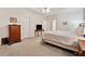 Large bedroom featuring carpet, a tray ceiling, and plenty of natural light at 2722 Brookhaven Ln, Buford, GA 30518
