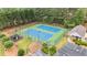 Overhead view featuring dual tennis courts with lush landscaping and a playground in a gated community at 2722 Brookhaven Ln, Buford, GA 30518