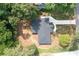 An aerial view of a home, showcasing its roof, driveway, and surrounding trees and landscaping at 3590 Lee Se St, Smyrna, GA 30080