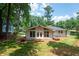 Home featuring a well-manicured lawn and covered back porch at 3590 Lee Se St, Smyrna, GA 30080