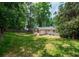 Backyard showcasing a well-maintained lawn and mature tree coverage at 3590 Lee Se St, Smyrna, GA 30080