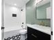 Bathroom features modern fixtures, tiled floors, shower with black hardware, and decorative mirror at 3590 Lee Se St, Smyrna, GA 30080