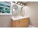 Bathroom featuring double sink vanity and modern light fixtures at 3590 Lee Se St, Smyrna, GA 30080