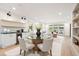 Open-concept dining area featuring sleek modern design, built in cabinets with a wine fridge, and natural light at 3590 Lee Se St, Smyrna, GA 30080