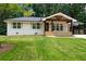 Charming single-story home with a well-manicured lawn and inviting front porch at 3590 Lee Se St, Smyrna, GA 30080