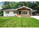 Charming single-story home boasting a spacious front yard with mature trees and a welcoming front porch at 3590 Lee Se St, Smyrna, GA 30080