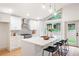 Modern kitchen with white cabinets, quartz countertops, stainless steel appliances, and an eat-in island with bar seating at 3590 Lee Se St, Smyrna, GA 30080