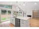 Bright kitchen boasts stainless steel appliances, pendant lights, and a large island overlooking the yard at 3590 Lee Se St, Smyrna, GA 30080