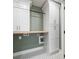 Laundry room with built-in cabinets, folding counter, and modern finishes at 3590 Lee Se St, Smyrna, GA 30080