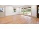 Bright living room with hardwood floors, large windows offering outdoor views, and a dark wood door at 3590 Lee Se St, Smyrna, GA 30080