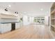 Sunlit living area with hardwood floors, built-in shelving, and a convenient mini fridge at 3590 Lee Se St, Smyrna, GA 30080
