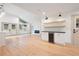 Bright living room with fireplace, mini fridge, and hardwood floors at 3590 Lee Se St, Smyrna, GA 30080