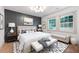 Stylish bedroom with a decorative wall, hardwood floors, ample natural light, and elegant furnishings at 3590 Lee Se St, Smyrna, GA 30080