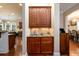 Elegant bar area with dark wood cabinets, granite countertop, and stylish lighting at 13042 Dartmore Ave, Alpharetta, GA 30005
