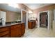 Primary bath featuring a dual sink vanity, tile floors and granite countertops at 13042 Dartmore Ave, Alpharetta, GA 30005