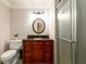 Bathroom with a custom vanity, framed oval mirror, and a glass door shower at 13042 Dartmore Ave, Alpharetta, GA 30005