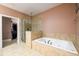 Luxurious bathroom featuring a separate shower and a soaking tub at 13042 Dartmore Ave, Alpharetta, GA 30005