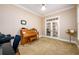 Cozy bedroom showcasing a piano, a desk, and French doors that offers lots of natural light at 13042 Dartmore Ave, Alpharetta, GA 30005