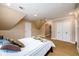 Spacious bedroom featuring neutral walls, a large closet, and plush carpet flooring at 13042 Dartmore Ave, Alpharetta, GA 30005