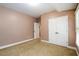 Spacious room featuring carpeted flooring and neutral colored walls with white trim at 13042 Dartmore Ave, Alpharetta, GA 30005