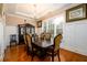 Formal dining room with hardwood floors, a chandelier, and wainscoting, perfect for elegant gatherings at 13042 Dartmore Ave, Alpharetta, GA 30005