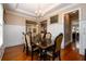 Formal dining room with hardwood floors, wainscoting, chandelier, and elegant table set for sophisticated dining at 13042 Dartmore Ave, Alpharetta, GA 30005